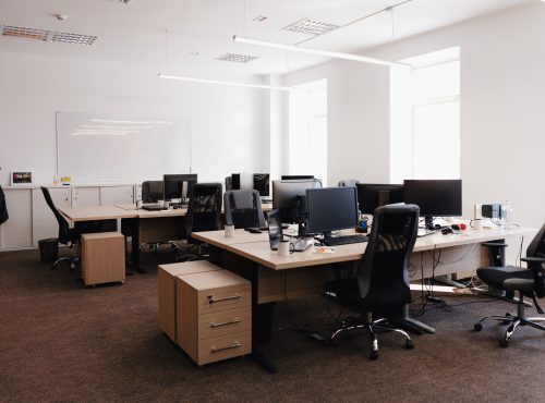 IT open space office. Computer Work Stations. Office Workplace with windows.
